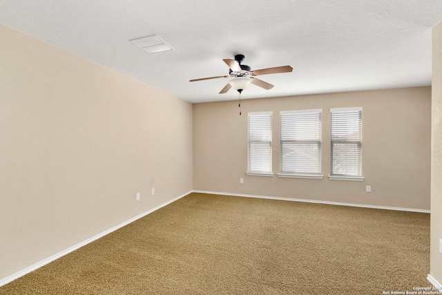 carpeted empty room with a textured ceiling and ceiling fan