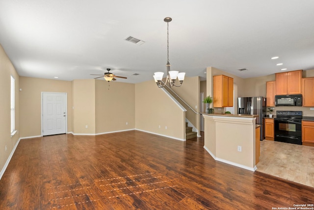 kitchen featuring dark hardwood / wood-style flooring, decorative light fixtures, ceiling fan with notable chandelier, and black appliances