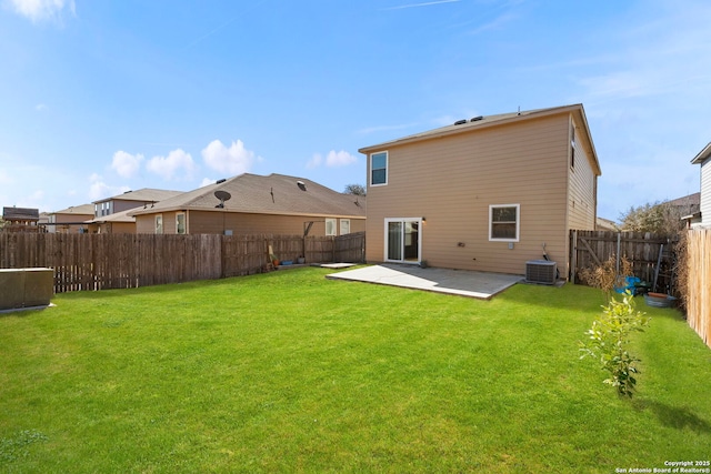 rear view of property with a yard, a patio area, and central AC