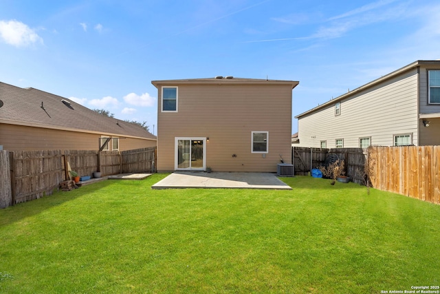 rear view of property featuring a yard, a patio, and central air condition unit