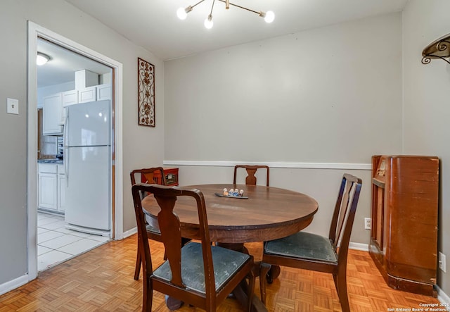 dining area featuring light parquet floors