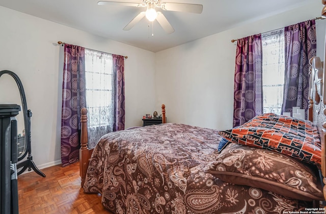 bedroom with parquet floors and ceiling fan