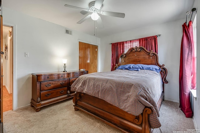 bedroom featuring light carpet and ceiling fan