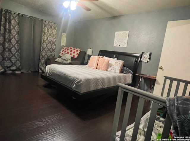 bedroom featuring hardwood / wood-style floors and ceiling fan