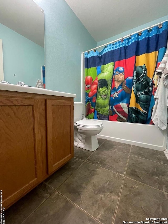 bathroom featuring shower / bathtub combination with curtain, tile patterned floors, and toilet