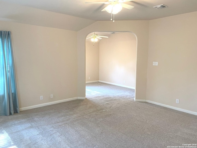 carpeted empty room with lofted ceiling and ceiling fan