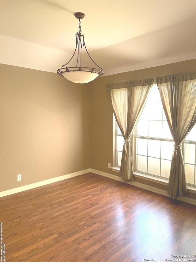 empty room with dark hardwood / wood-style flooring