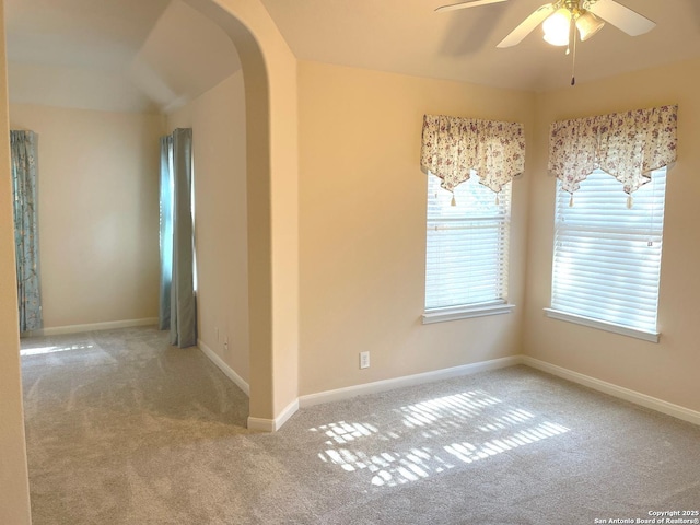 carpeted empty room featuring ceiling fan