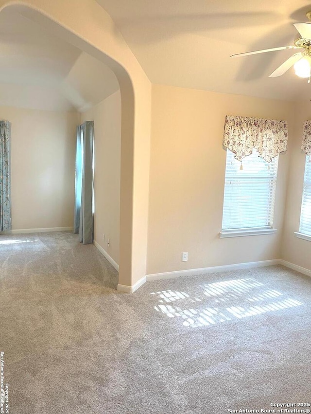 carpeted spare room with ceiling fan