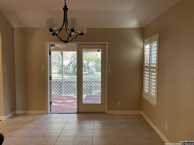 entryway with a chandelier and light tile patterned flooring