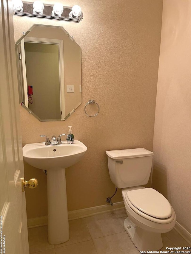 bathroom with sink, tile patterned floors, and toilet