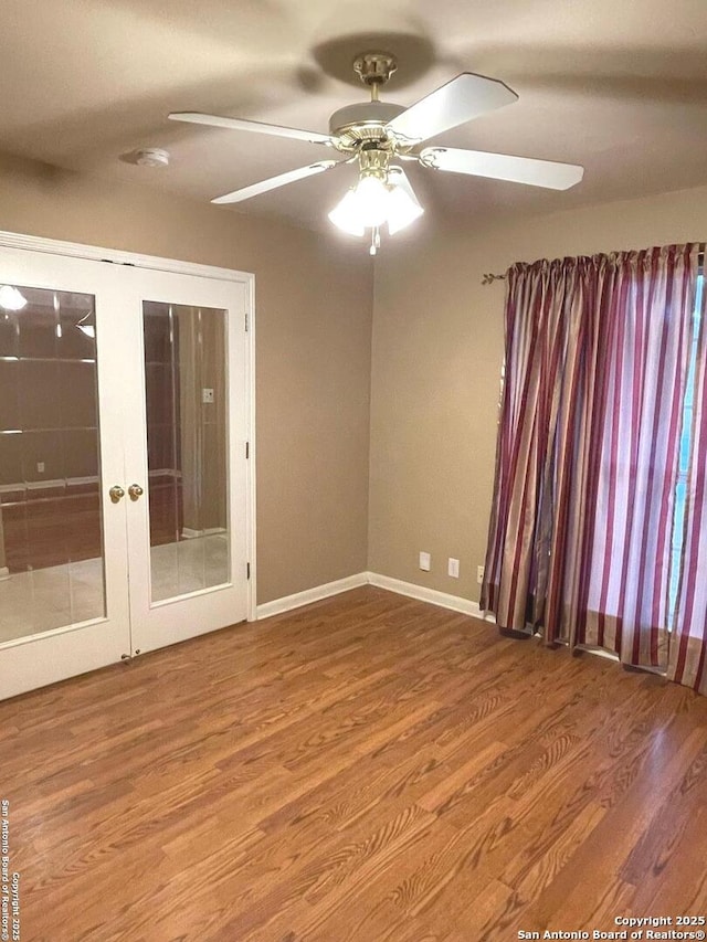 unfurnished room with hardwood / wood-style flooring, ceiling fan, and french doors