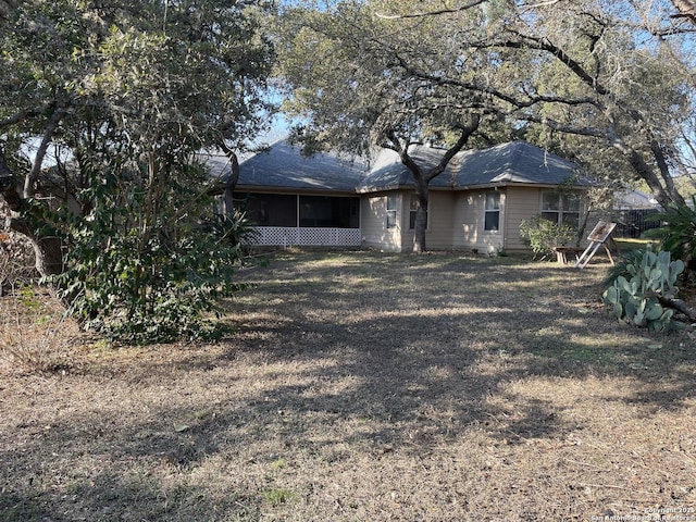 rear view of property with a sunroom