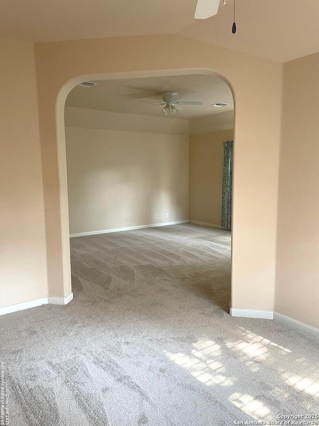 carpeted spare room featuring ceiling fan