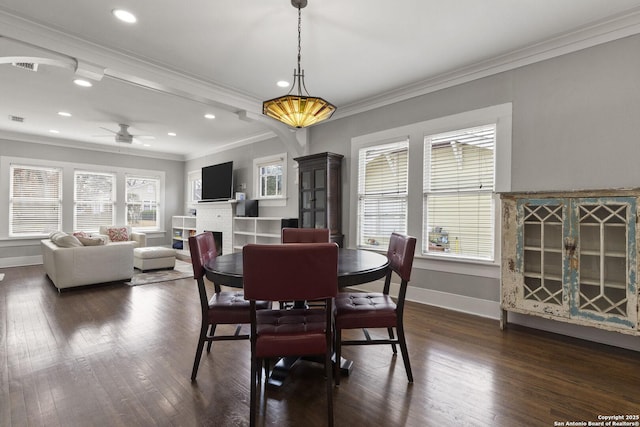 dining space featuring ceiling fan, ornamental molding, dark hardwood / wood-style floors, and a brick fireplace