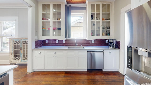 kitchen featuring white cabinetry, appliances with stainless steel finishes, dark hardwood / wood-style flooring, and sink