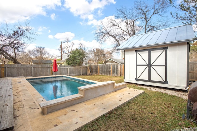 view of swimming pool featuring a yard and a storage unit