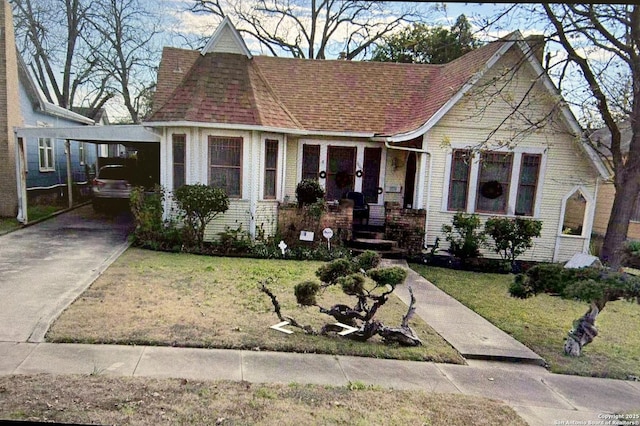 view of front facade with a carport and a front yard