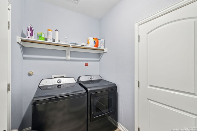 clothes washing area featuring washing machine and clothes dryer