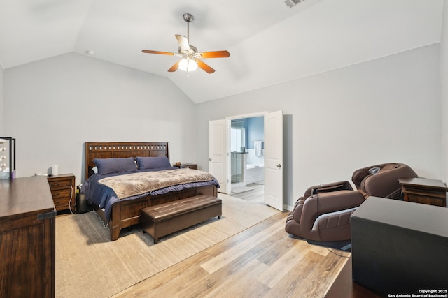 bedroom with lofted ceiling, ensuite bath, ceiling fan, and light hardwood / wood-style flooring