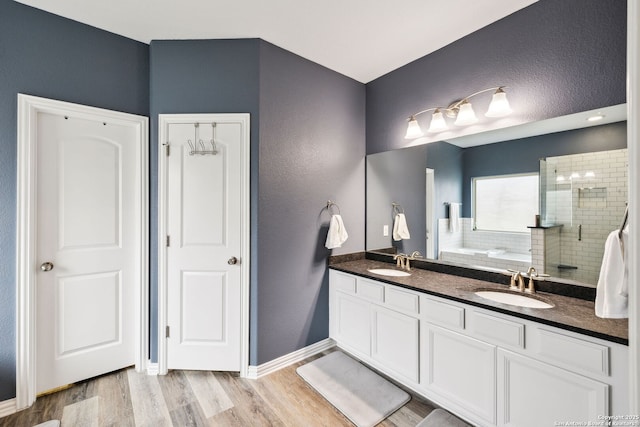 bathroom with an enclosed shower, vanity, and hardwood / wood-style flooring