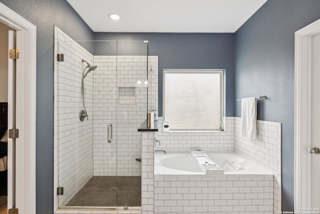 bathroom featuring separate shower and tub