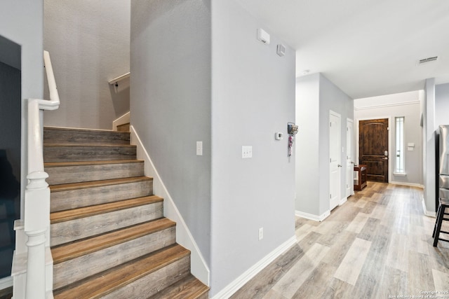 stairs featuring hardwood / wood-style floors