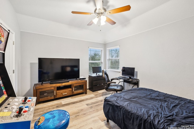 bedroom with light hardwood / wood-style floors and ceiling fan