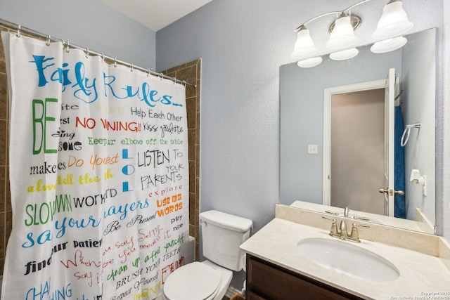 full bathroom with vanity, shower / tub combo, and toilet