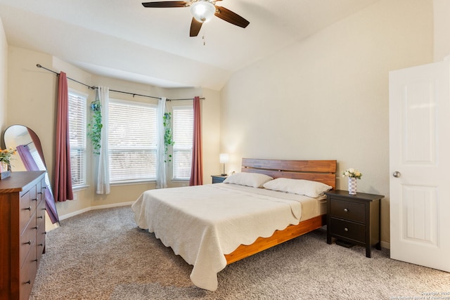 bedroom with ceiling fan, vaulted ceiling, and light carpet