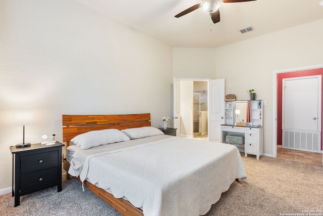 bedroom featuring ceiling fan, ensuite bathroom, and carpet flooring