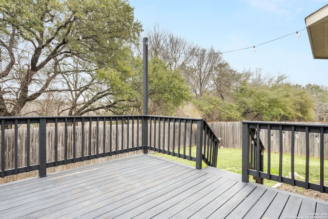 wooden terrace with a lawn