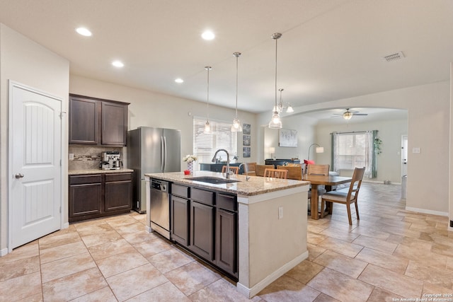 kitchen featuring pendant lighting, sink, dishwasher, a kitchen island with sink, and dark brown cabinetry