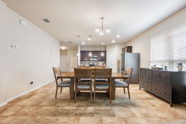 dining space with a notable chandelier