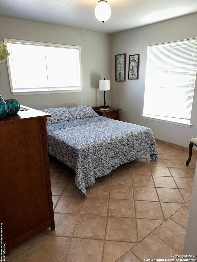 bedroom featuring light tile patterned floors