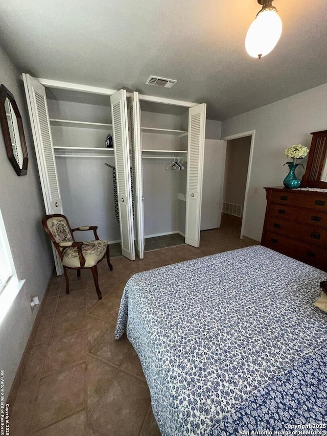 tiled bedroom with two closets