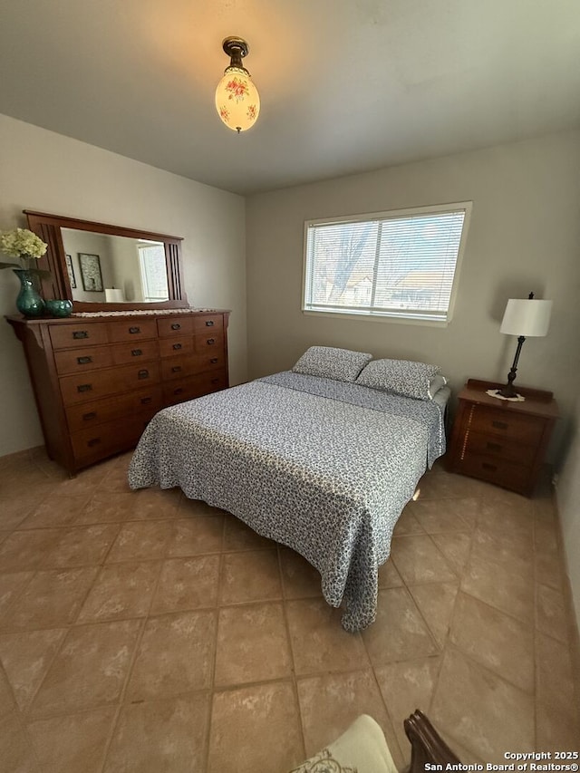 bedroom with light tile patterned floors