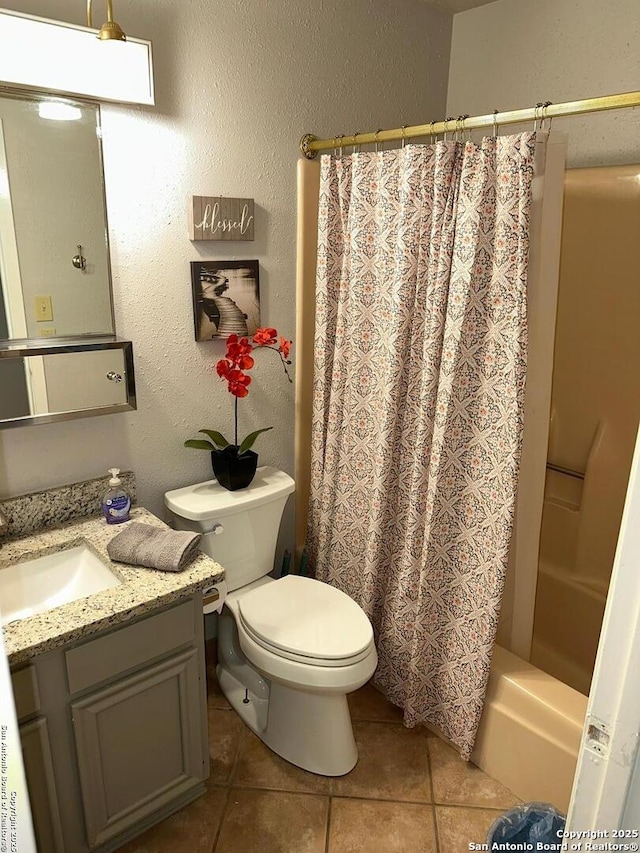 full bathroom with tile patterned flooring, vanity, shower / bathtub combination with curtain, and toilet