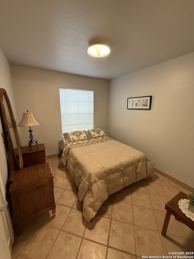 bedroom with light tile patterned flooring