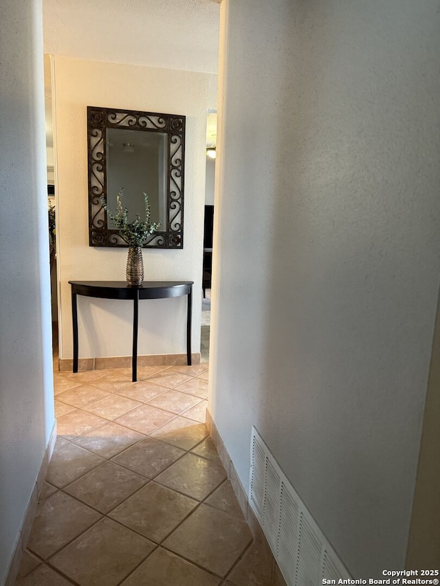 hall with light tile patterned floors