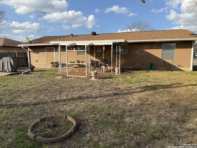 back of property featuring a lawn and a patio