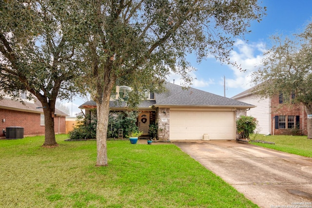 view of front of house with a garage, a front yard, and cooling unit