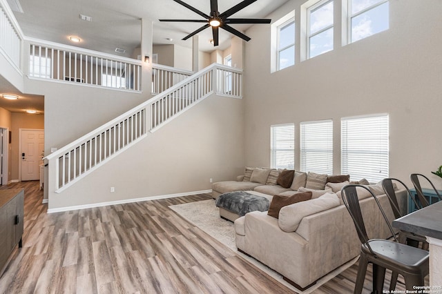 living room with hardwood / wood-style floors and ceiling fan