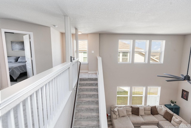 stairs featuring a wealth of natural light and a textured ceiling