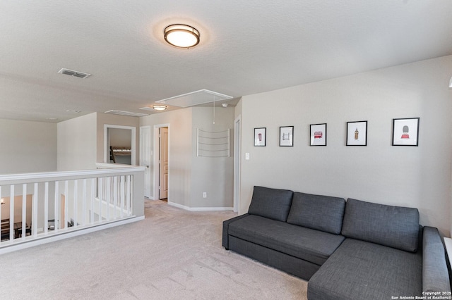 living room featuring light carpet and a textured ceiling