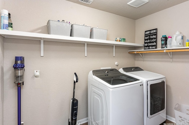 clothes washing area featuring washing machine and dryer