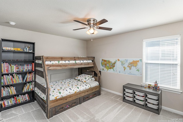 bedroom with ceiling fan and light colored carpet