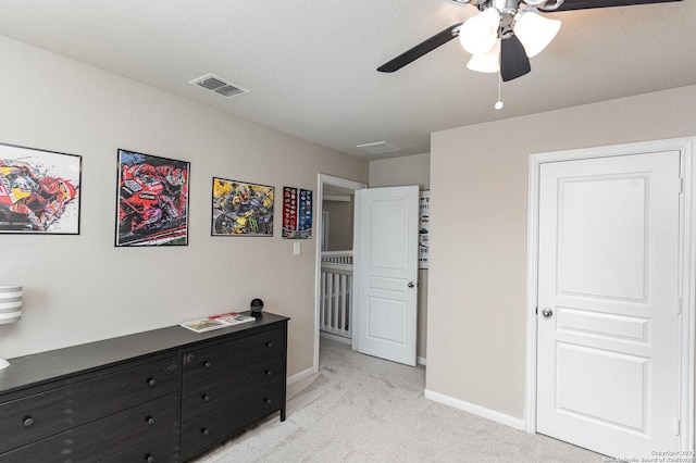 bedroom with ceiling fan and light carpet