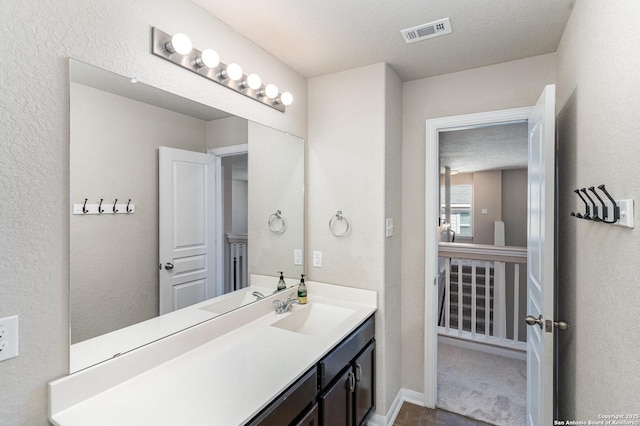 bathroom featuring vanity and a textured ceiling