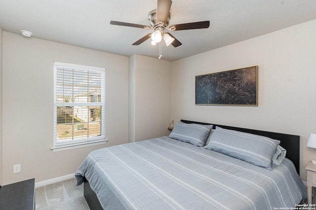 bedroom featuring light carpet and ceiling fan